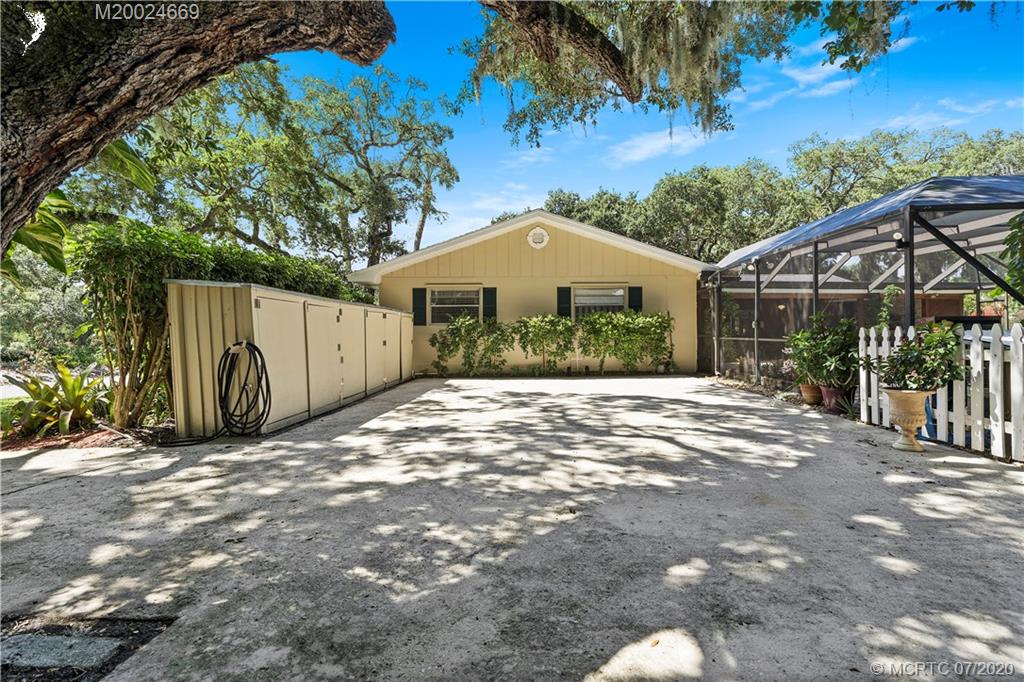 15 Banyan Road Stuart, FL 34996 - Photo 40 of 52 Additional parking for extra cars, vehicles, even boat that would be screened from view. Existing storage. Note the extra driveway coming into rear of the property.