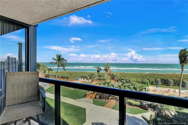 a view of a balcony with an ocean view
