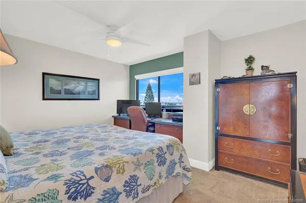 a bedroom with a bed and painting on the wall