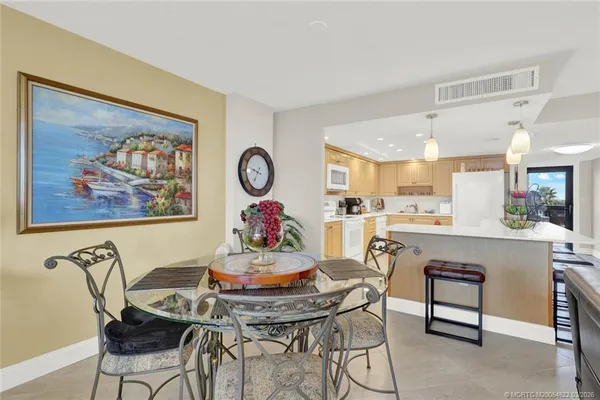 a dining room with furniture water view and a large window