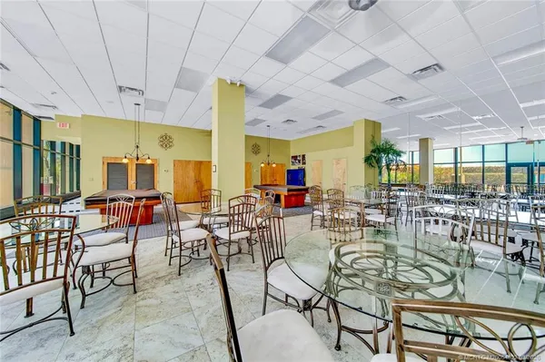 a room with pool table and windows