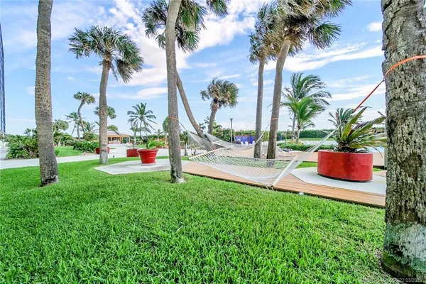 a view of swimming pool with a lounge chairs