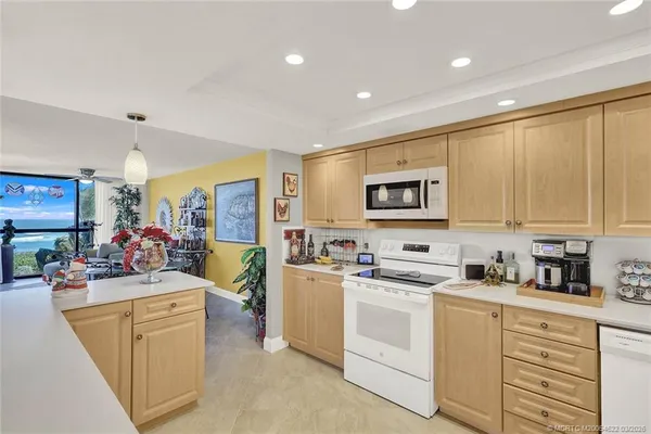 a kitchen with a sink a refrigerator and cabinets