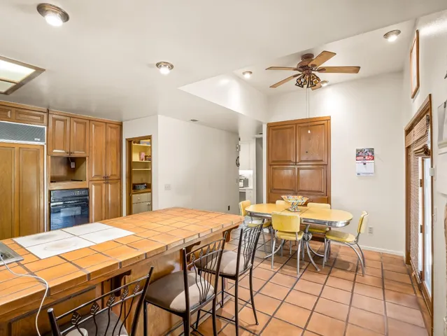 a kitchen with a sink a stove a dining table and chairs