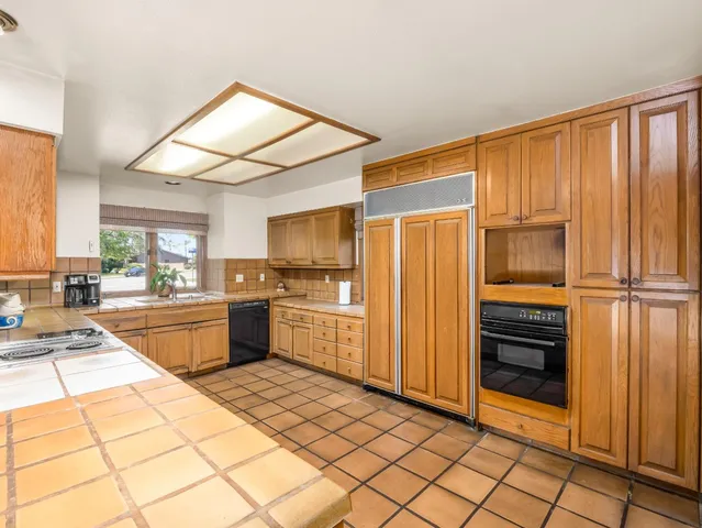 a kitchen with stainless steel appliances granite countertop a sink and cabinets