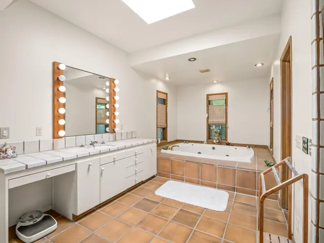 a bath tub sitting next to a bathroom sink