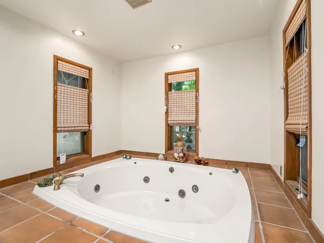 a large bathroom with a double vanity sink mirror and