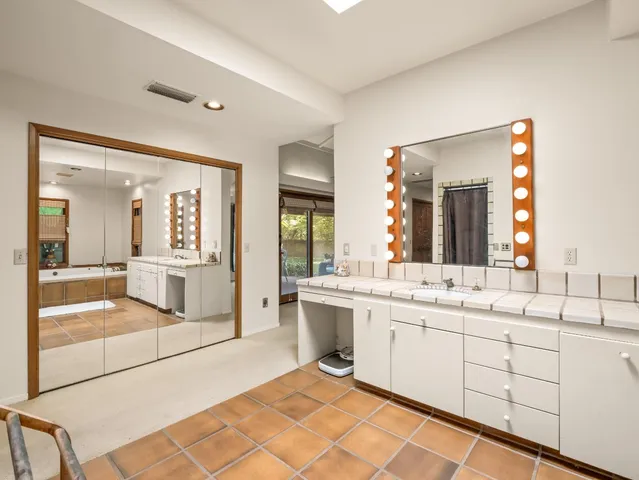 a view of an empty room with a fireplace and a window