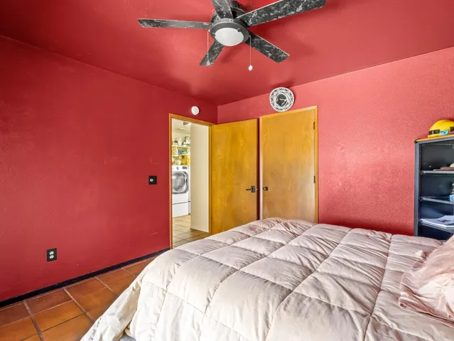 a bathroom with a granite countertop sink a toilet and a mirror