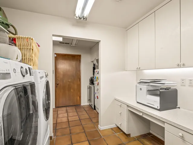 a view of patio with a table and chairs under an umbrella