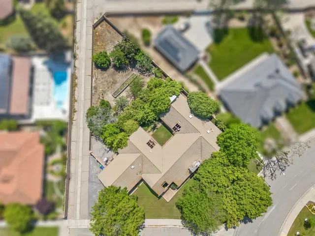 an aerial view of a house with garden space and street view