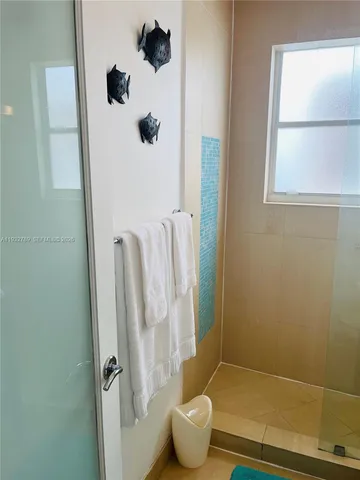 a utility room with wooden floor and washing machine