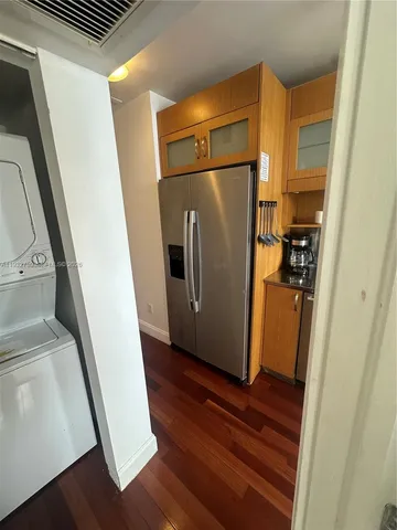 a view of a hallway with wooden floor and stairs