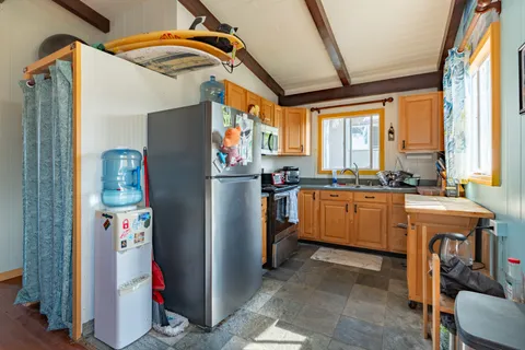 a bedroom with a bed next to a window