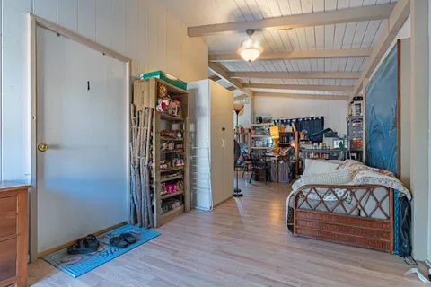 a living room with furniture a flat screen tv and a table