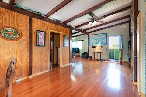 a living room with furniture a wooden floor and a large window