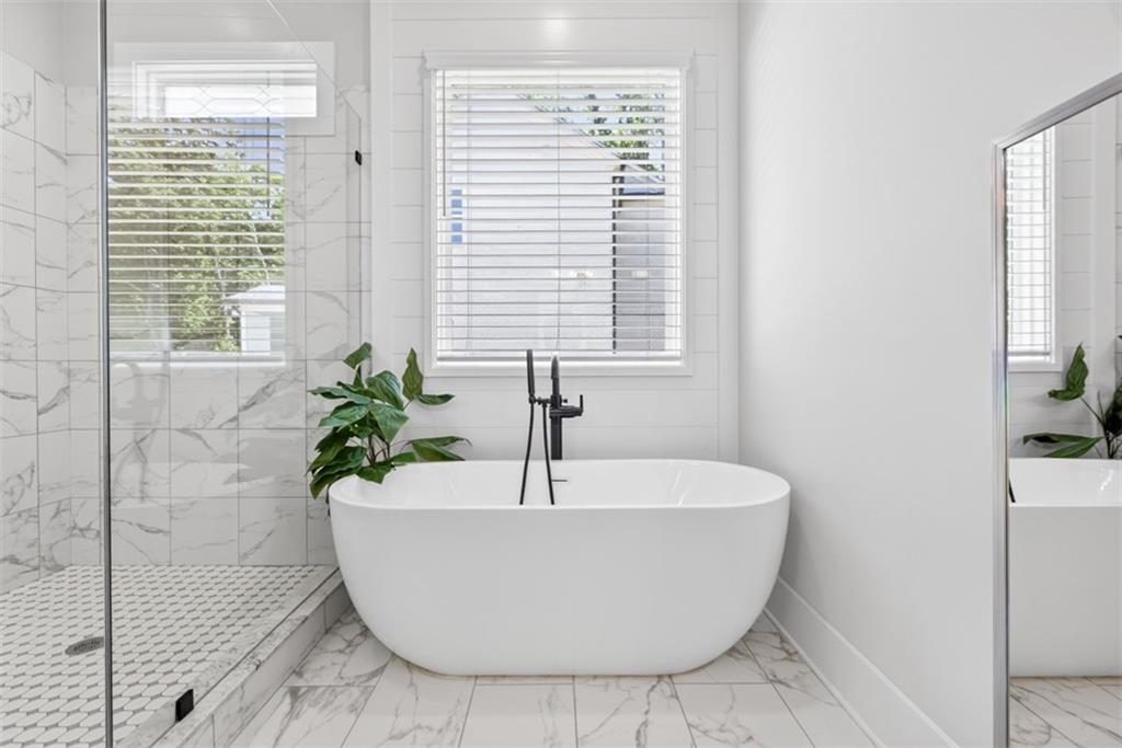 3528 North Bogan Road Buford, GA 30519 - Photo 27 of 79 a white bath tub sitting in a bathroom