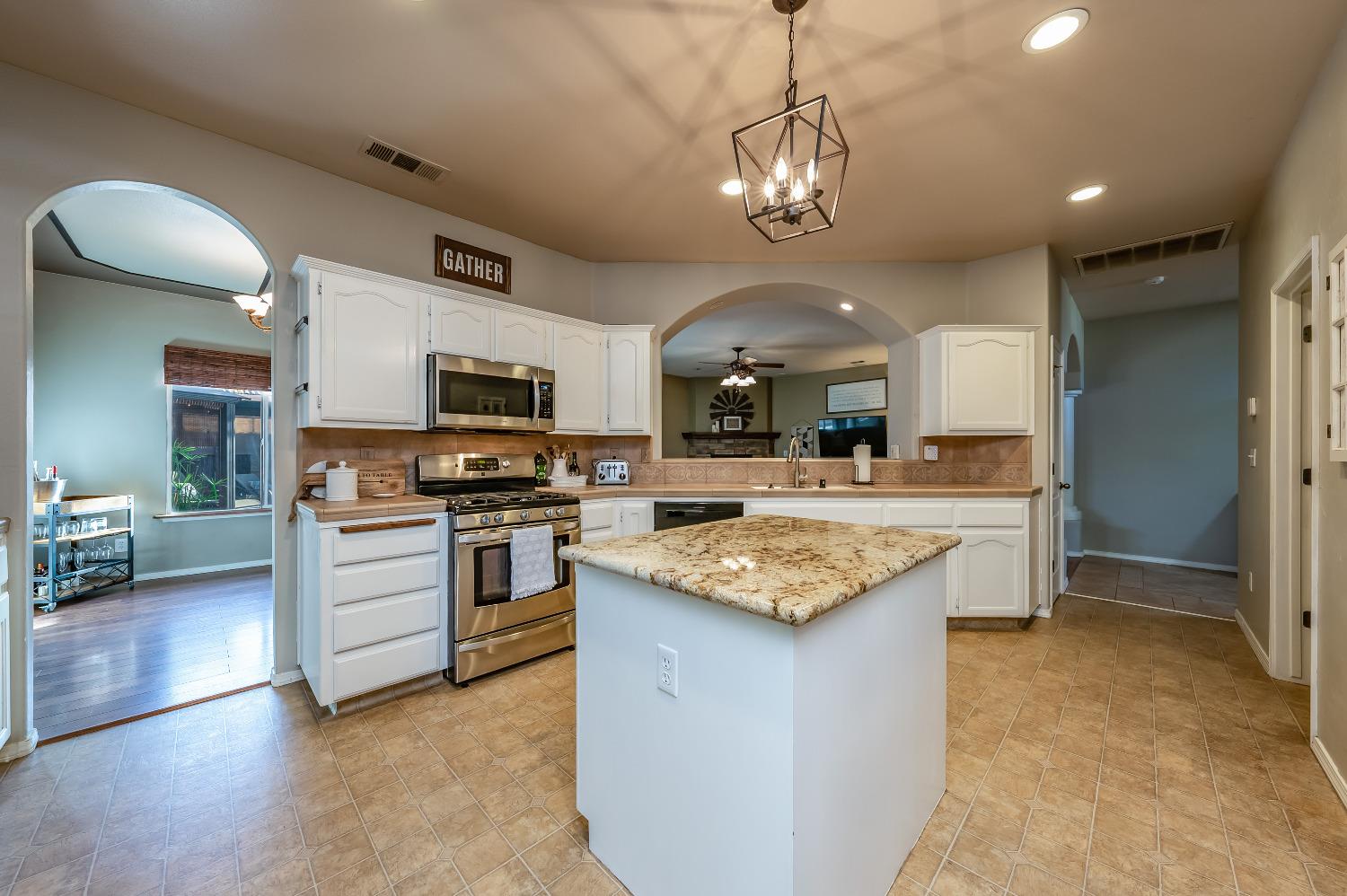 696 Crescent Lane Lemoore, CA 93245 - Photo 11 of 35 a large kitchen with a center island and stainless steel appliances