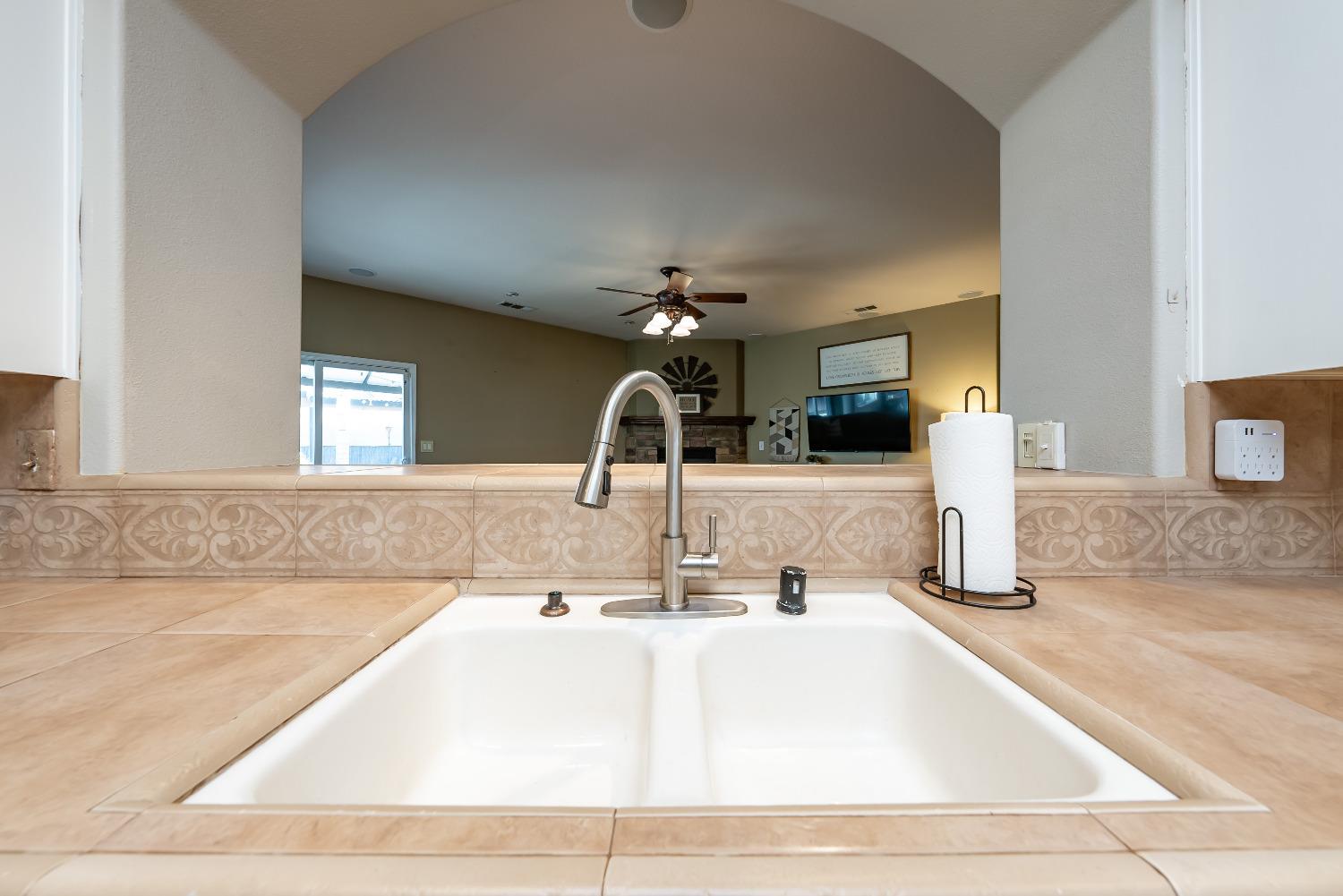 696 Crescent Lane Lemoore, CA 93245 - Photo 15 of 35 a kitchen with a sink and a mirror