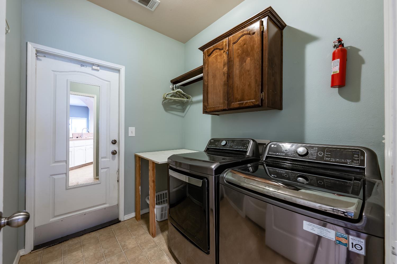 696 Crescent Lane Lemoore, CA 93245 - Photo 16 of 35 a utility room with dryer and washer
