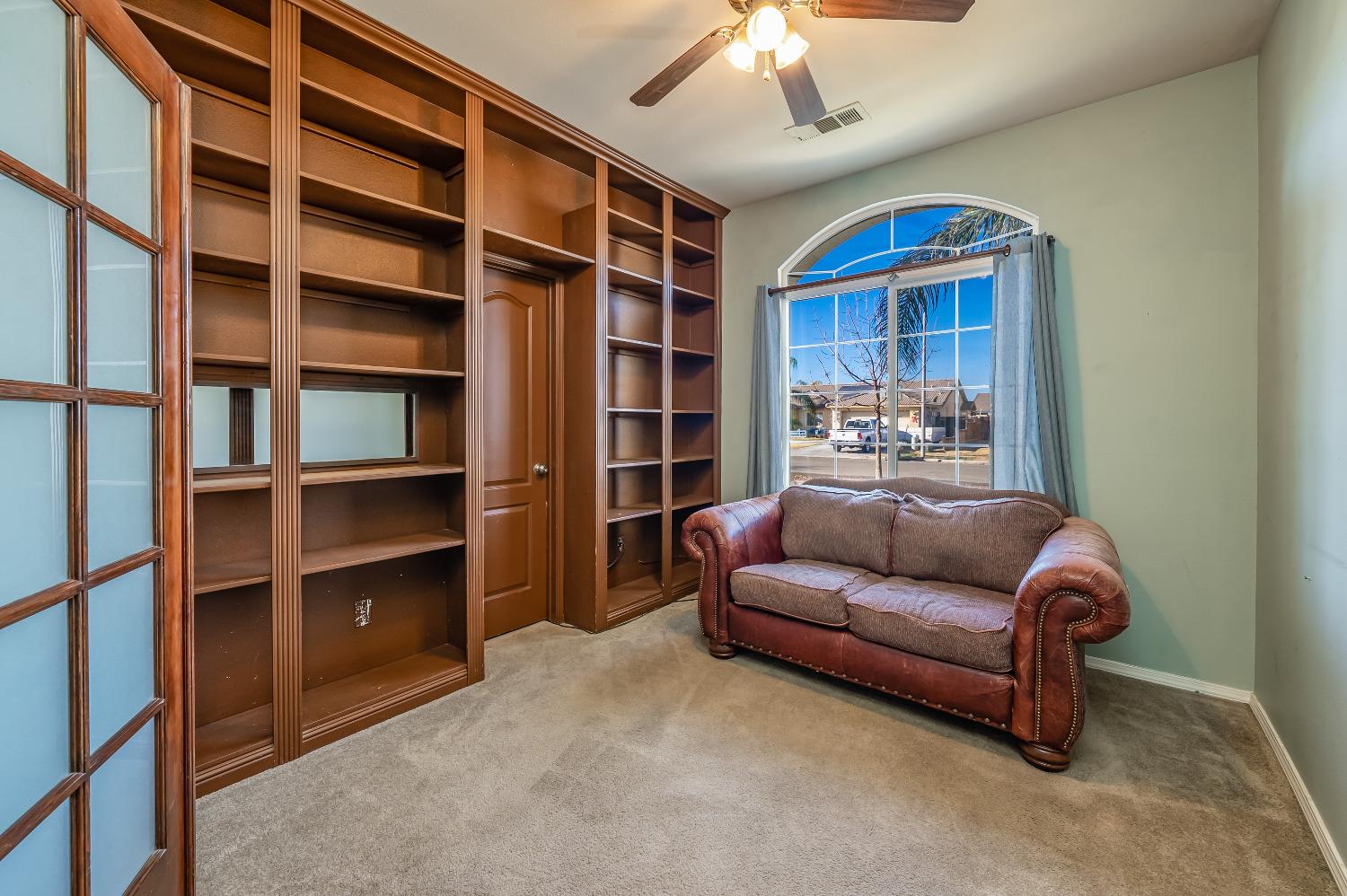 696 Crescent Lane Lemoore, CA 93245 - Photo 17 of 35 a living room with a furniture and a book shelf