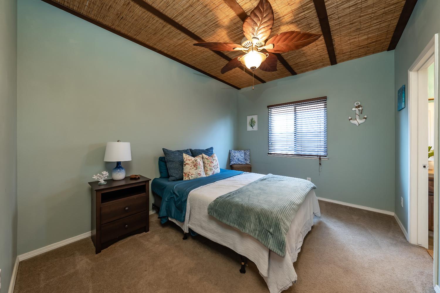 696 Crescent Lane Lemoore, CA 93245 - Photo 18 of 35 a bedroom with a bed and a chandelier