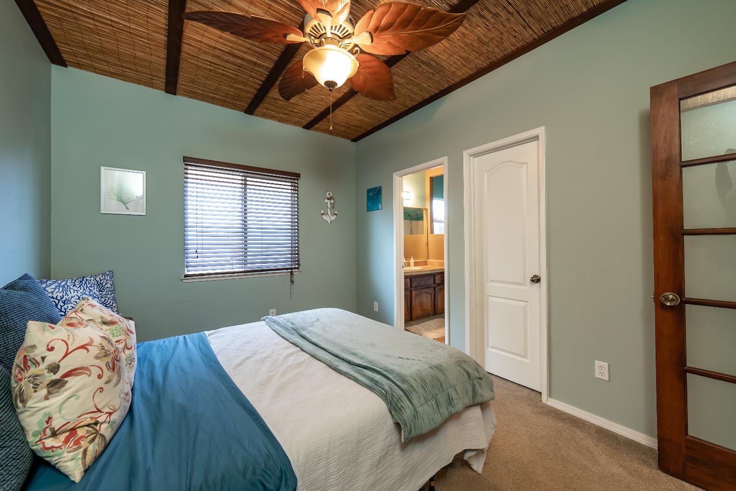 696 Crescent Lane Lemoore, CA 93245 - Photo 19 of 35 a bedroom with a bed and a chandelier