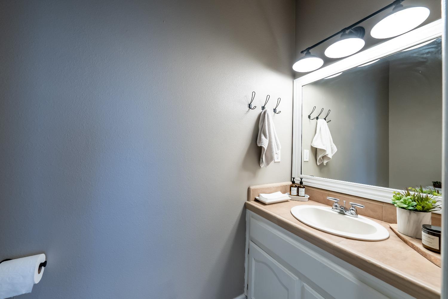 696 Crescent Lane Lemoore, CA 93245 - Photo 21 of 35 a bathroom with a sink and a mirror