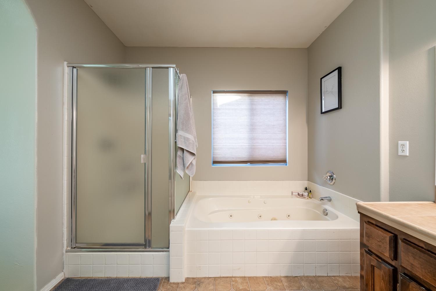 696 Crescent Lane Lemoore, CA 93245 - Photo 26 of 35 a bathroom with a bathtub and a shower
