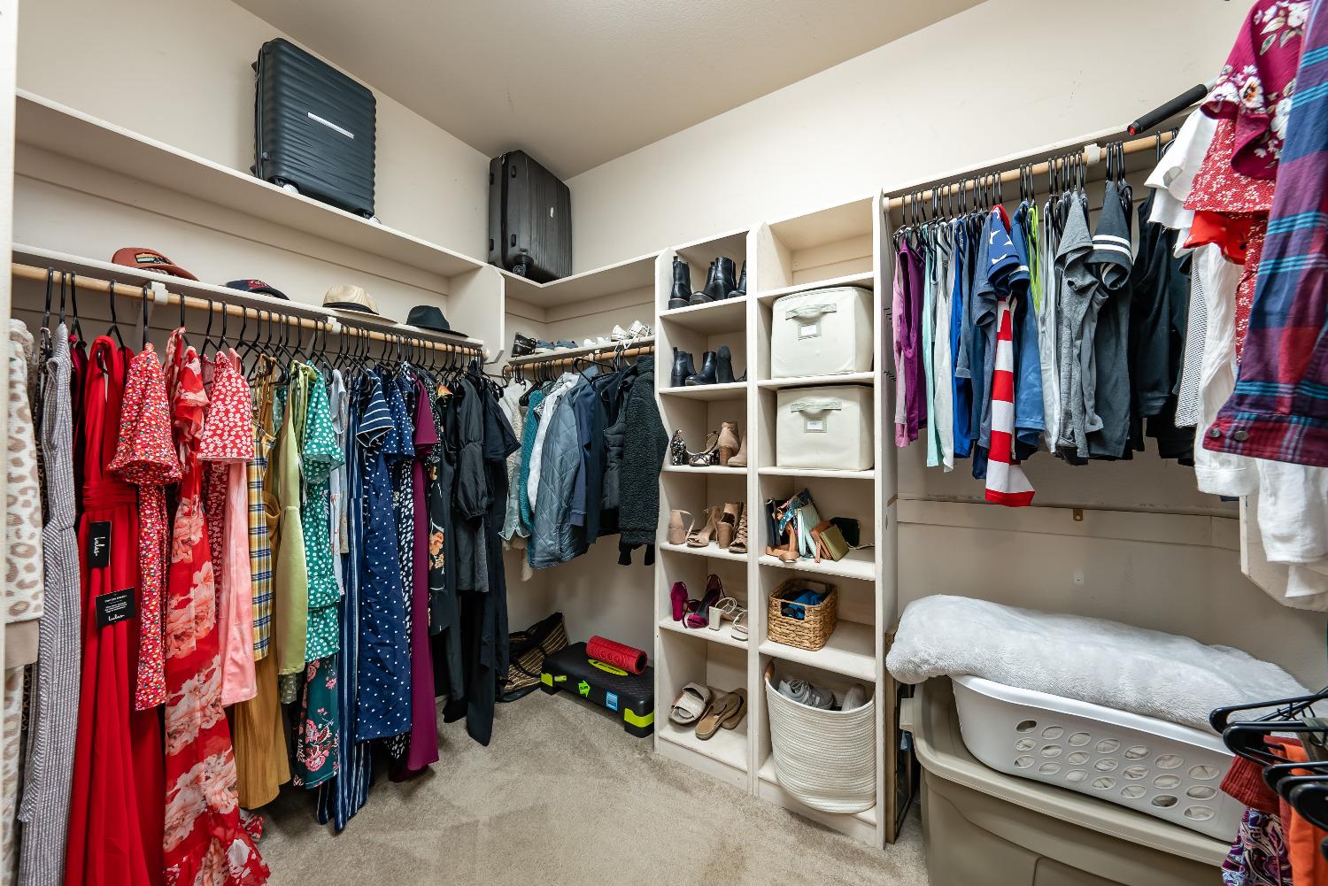 696 Crescent Lane Lemoore, CA 93245 - Photo 27 of 35 a view of walk in closet with clothes and shoes