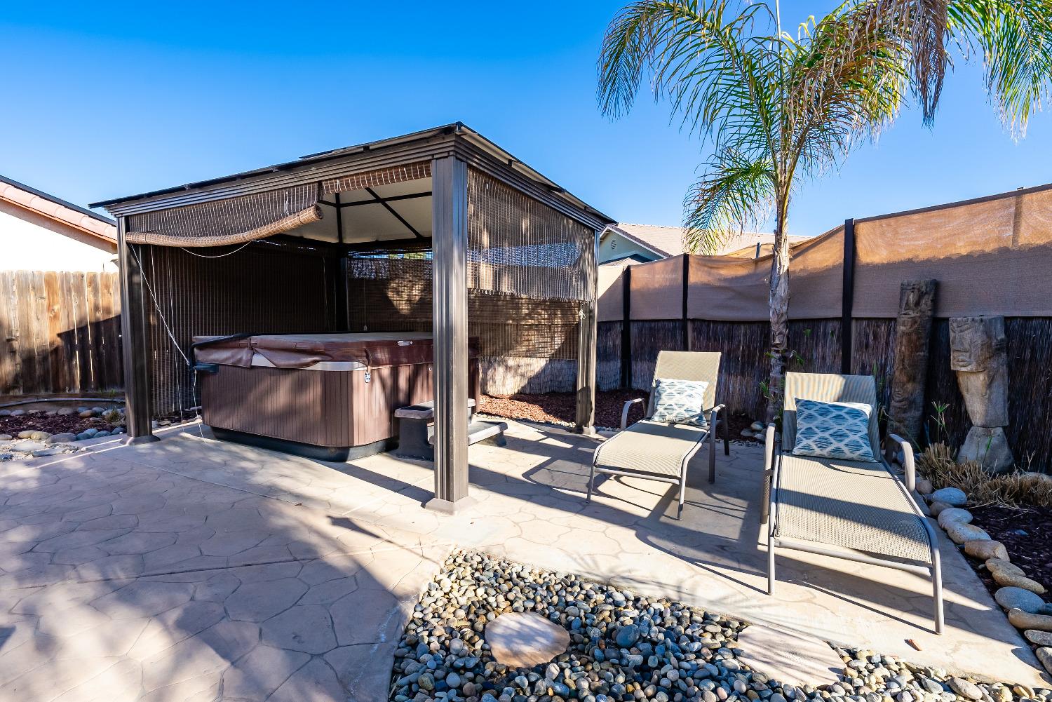 696 Crescent Lane Lemoore, CA 93245 - Photo 32 of 35 a view of a patio with a table and chairs under an umbrella