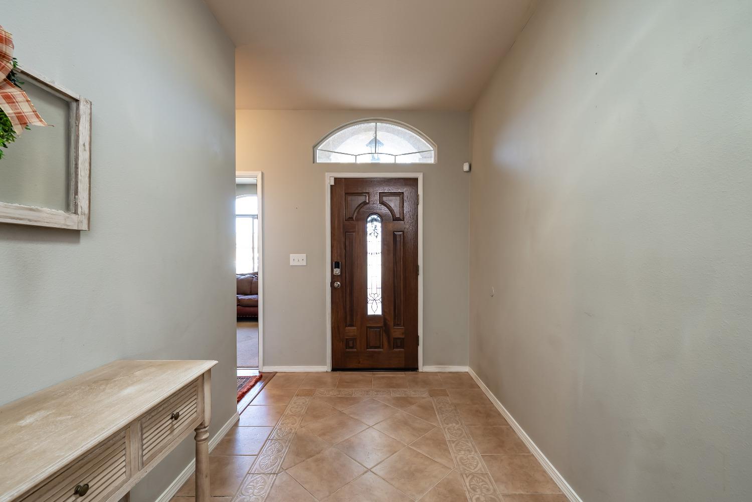696 Crescent Lane Lemoore, CA 93245 - Photo 4 of 35 a view of a hallway with wooden floor and a sink