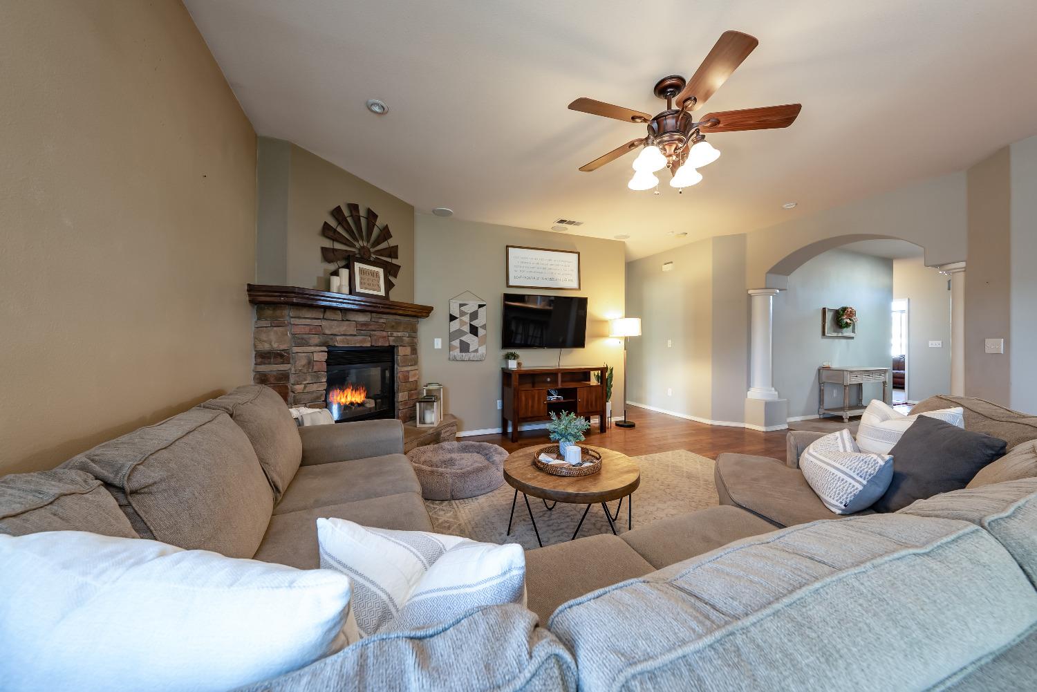 696 Crescent Lane Lemoore, CA 93245 - Photo 6 of 35 a living room with furniture a fireplace and a window
