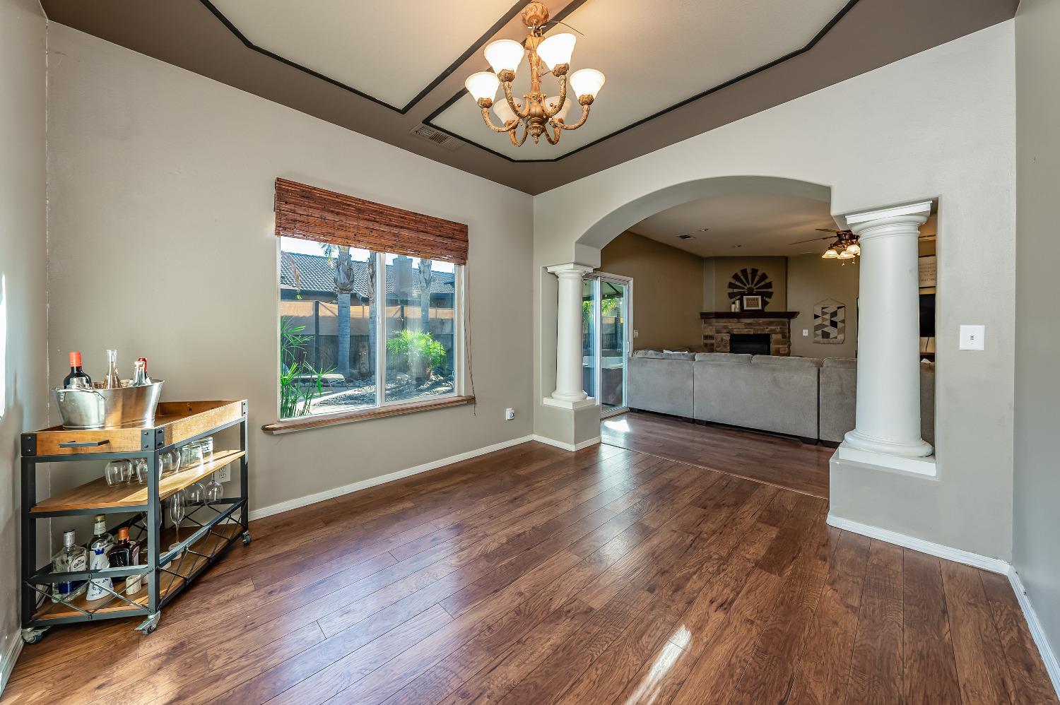 696 Crescent Lane Lemoore, CA 93245 - Photo 8 of 35 a view of a livingroom with wooden floor and a ceiling fan