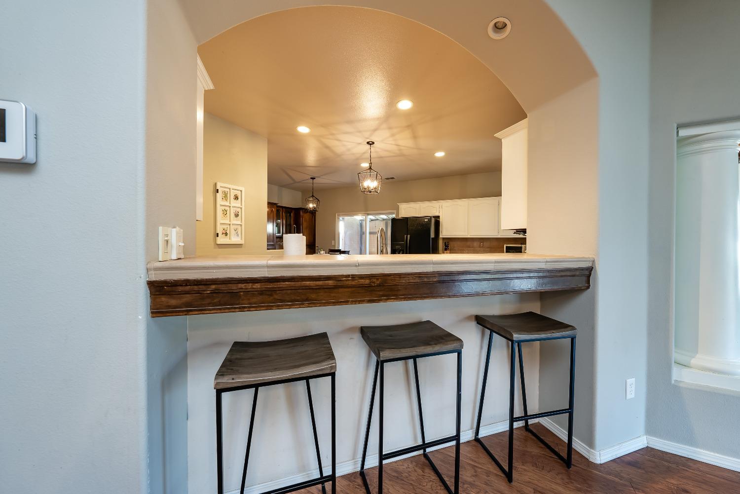 696 Crescent Lane Lemoore, CA 93245 - Photo 9 of 35 a kitchen with a table and chairs in it