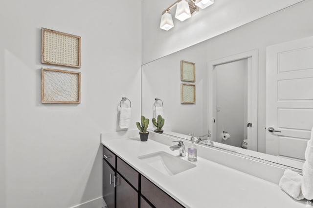 1122 South 1790th Street West, Unit 2 St. George, UT 84770 - Photo 20 of 37 Bathroom featuring a vanity with a white countertop, undermount sink, and dark wood-finish cabinetry