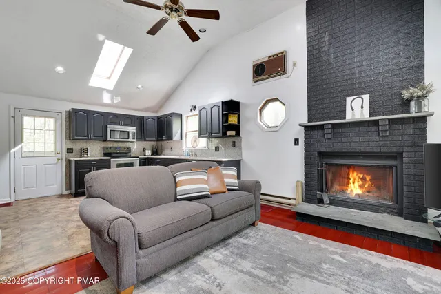 a view of a livingroom with furniture and a fireplace