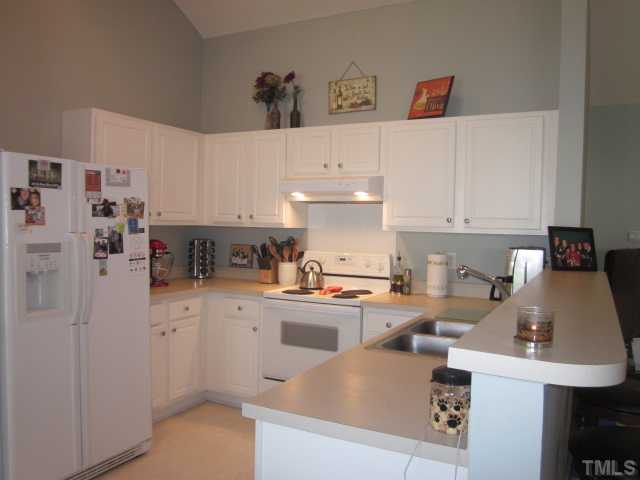 4553 Drewbridge Way Raleigh, NC 27604 - Photo 13 of 25 This wonderful kitchen features vaulted ceiling, updated range hood, updated dishwasher, bar & pantry! Refrigerator stays!