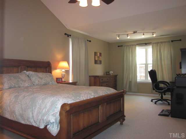 4553 Drewbridge Way Raleigh, NC 27604 - Photo 19 of 25 Look at your gorgeous new master bedroom that features the vaulted ceiling, a huge sitting area great for a multitude of uses, updated ceiling fan with light kit & remote, room is phone & cable ready, great walk-in closet, TV bracket for wall mounted TV!