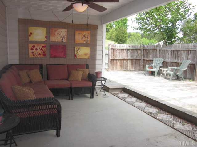 4553 Drewbridge Way Raleigh, NC 27604 - Photo 8 of 25 Here is the huge covered patio! Could be enclosed for a screen porch with approval! What a great outdoor living space featuring a ceiling fan with light kit!