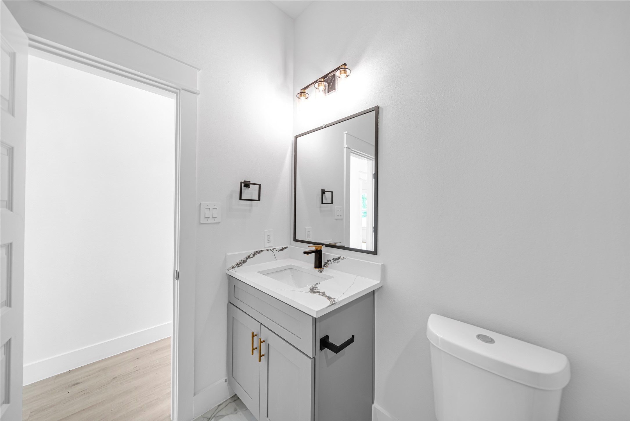 4902 Higgins Street, Unit B Houston, TX 77033 - Photo 23 of 24 a bathroom with a sink toilet and mirror