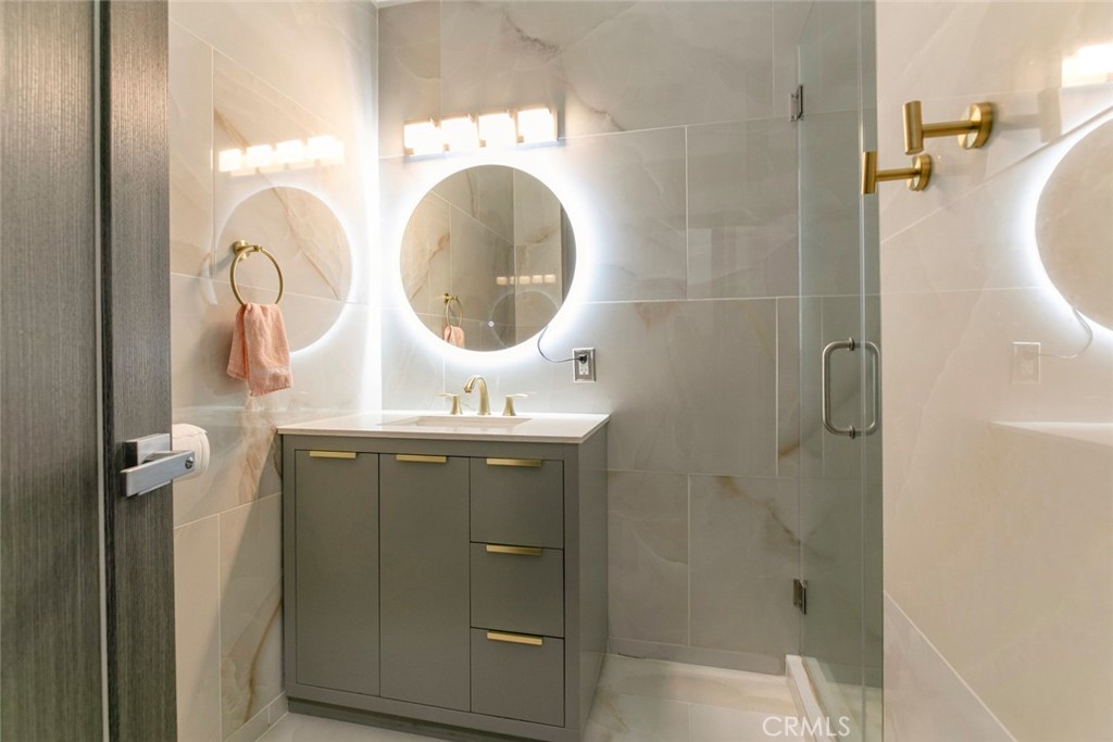 11836 Rialto Street Sun Valley, CA 91352 - Photo 11 of 23 a bathroom with a sink mirror and shower