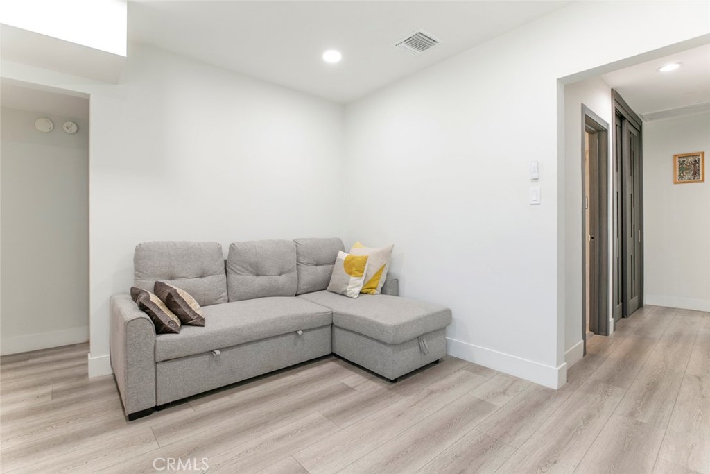 11836 Rialto Street Sun Valley, CA 91352 - Photo 12 of 23 a living room with furniture and a wooden floor