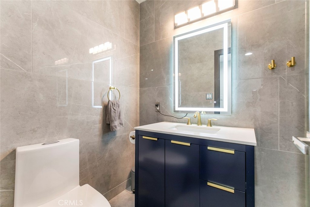11836 Rialto Street Sun Valley, CA 91352 - Photo 15 of 23 a bathroom with a sink and mirror with toilet