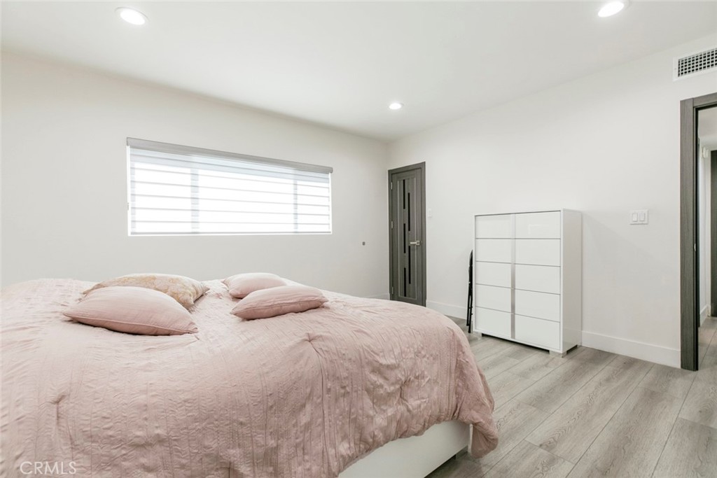 11836 Rialto Street Sun Valley, CA 91352 - Photo 18 of 23 a bedroom with a bed and wooden floor