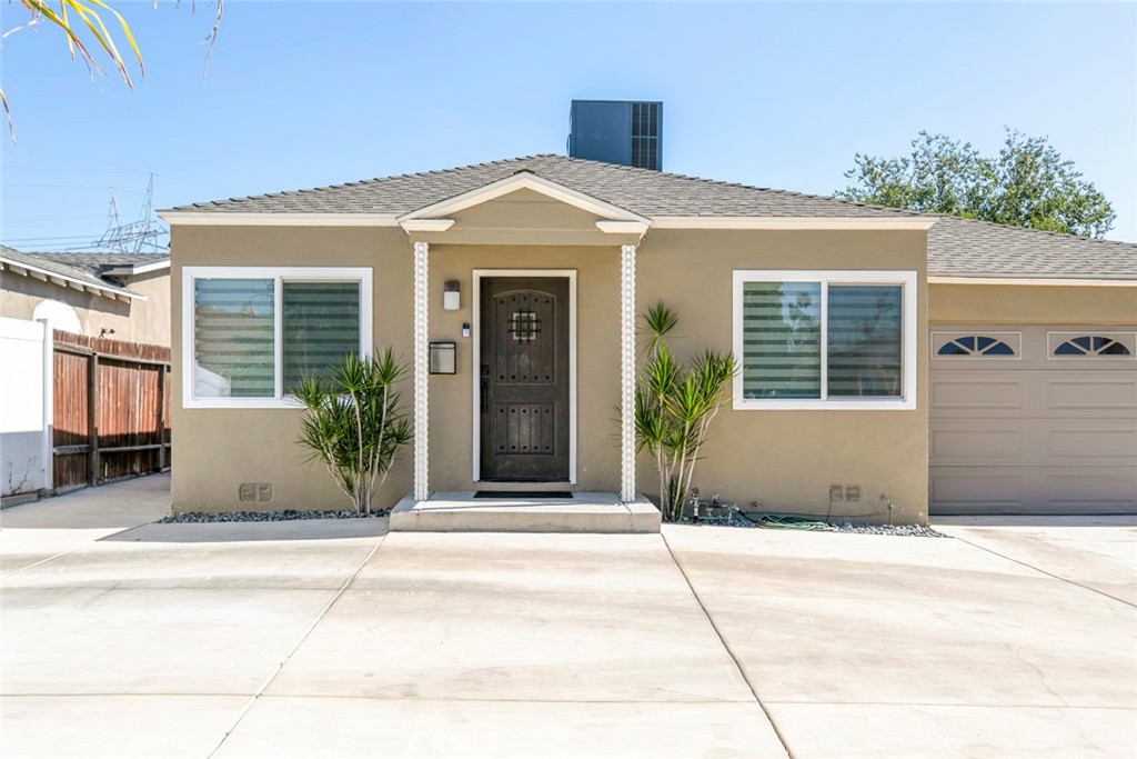 11836 Rialto Street Sun Valley, CA 91352 - Photo 3 of 23 a front view of a house with a garden