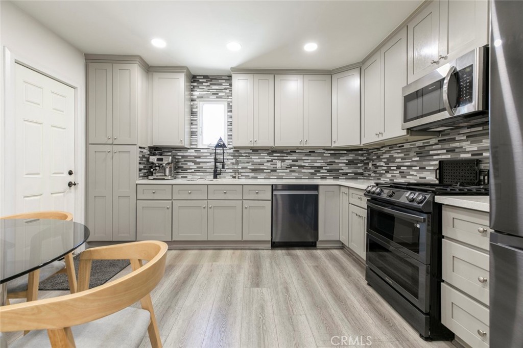 11836 Rialto Street Sun Valley, CA 91352 - Photo 8 of 23 a kitchen with stainless steel appliances granite countertop a sink stove and refrigerator