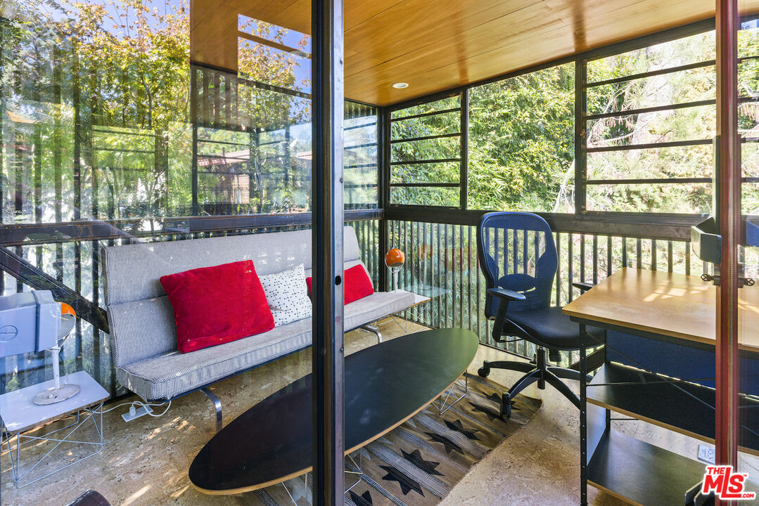 473 West Rustic Road Santa Monica, CA 90402 - Photo 15 of 34 a view of a living room and floor to ceiling window and wooden floor