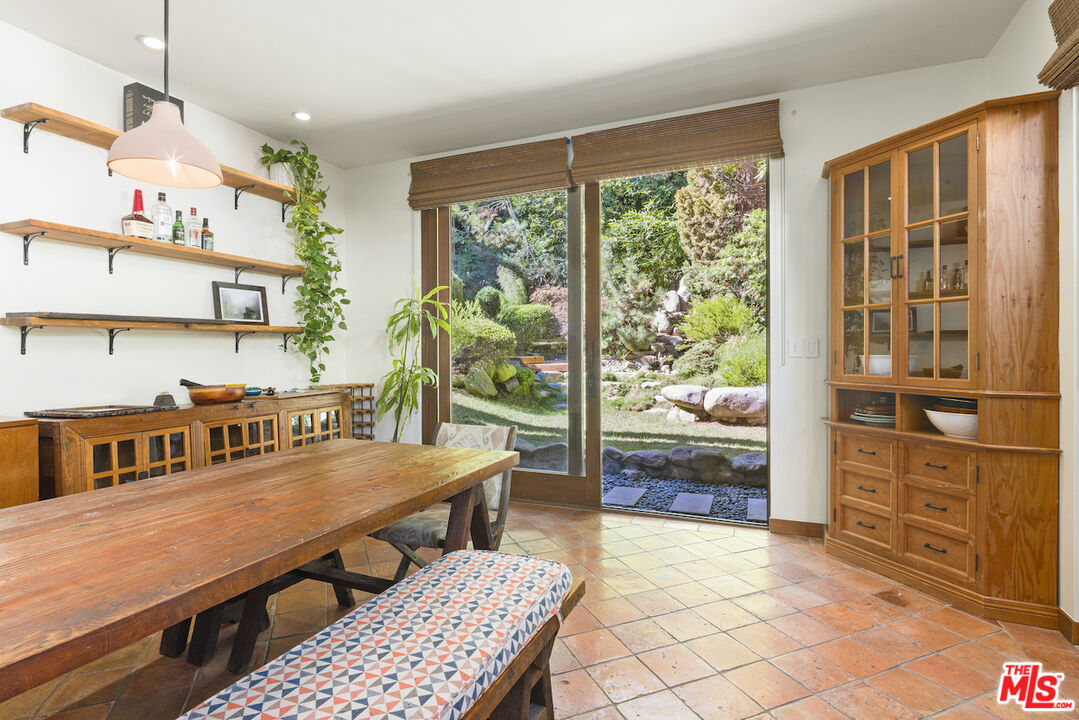 473 West Rustic Road Santa Monica, CA 90402 - Photo 9 of 34 a dining room with furniture a floor to ceiling window and wooden floor