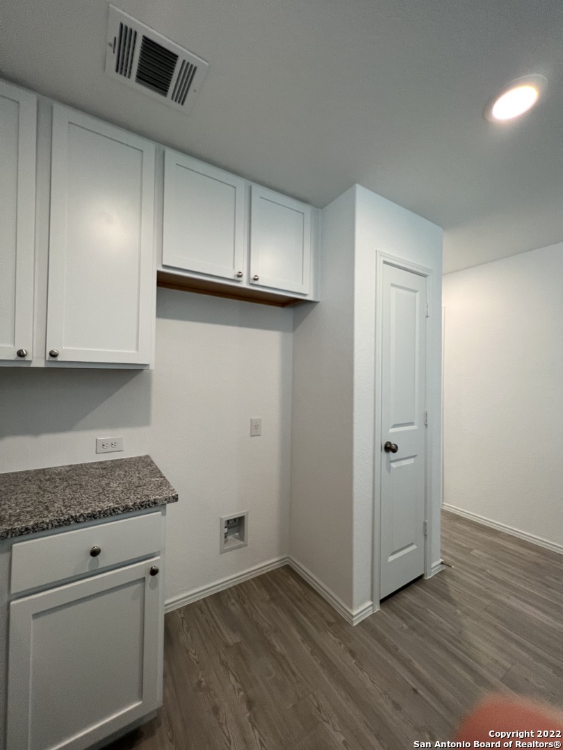 7314 Silos Ridge San Antonio, TX 78252 - Photo 12 of 45 a view of a kitchen with wooden floor and cabinets